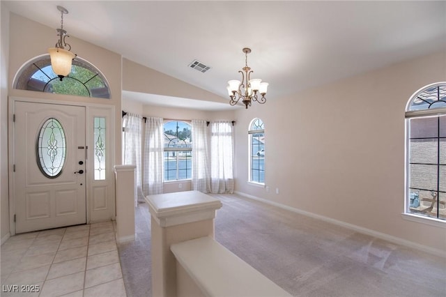 entrance foyer with visible vents, a notable chandelier, vaulted ceiling, and a healthy amount of sunlight