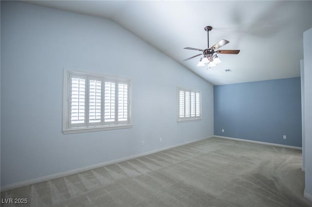 carpeted empty room featuring baseboards, visible vents, ceiling fan, and lofted ceiling
