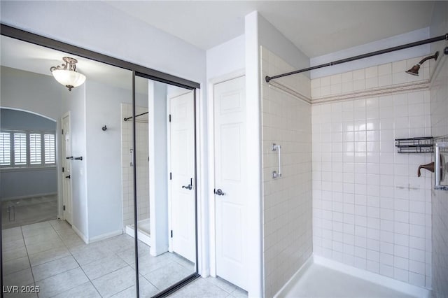 bathroom featuring tile patterned floors and a shower stall