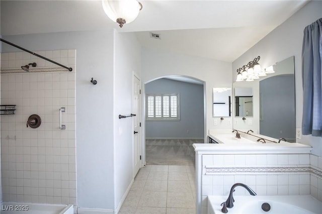 bathroom featuring a tub to relax in, visible vents, tile patterned floors, and baseboards