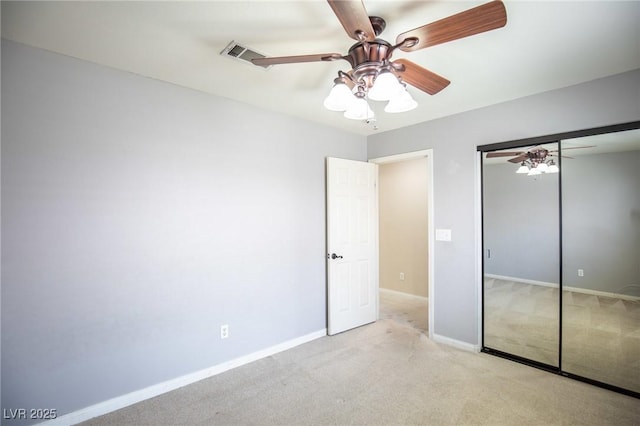 unfurnished bedroom featuring visible vents, a closet, baseboards, and carpet floors
