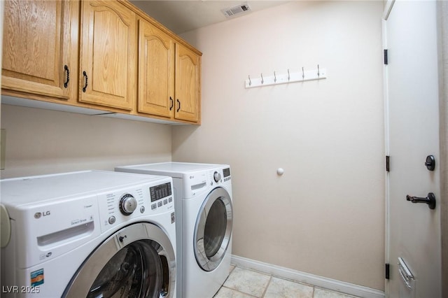 laundry room featuring cabinet space, washer and clothes dryer, light tile patterned flooring, visible vents, and baseboards