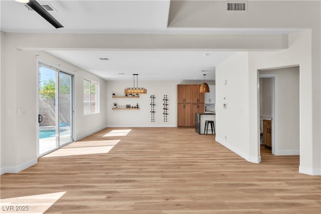 10613 Turquoise Valley Dr, Las Vegas, NV 89144 - unfurnished living room featuring baseboards, light wood-style flooring, and visible vents