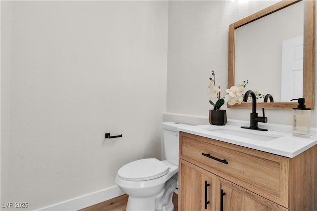 10613 Turquoise Valley Dr, Las Vegas, NV 89144 - half bath featuring toilet, baseboards, vanity, and wood finished floors