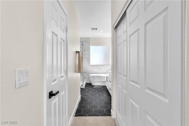 10613 Turquoise Valley Dr, Las Vegas, NV 89144 - corridor featuring dark tile patterned flooring and visible vents