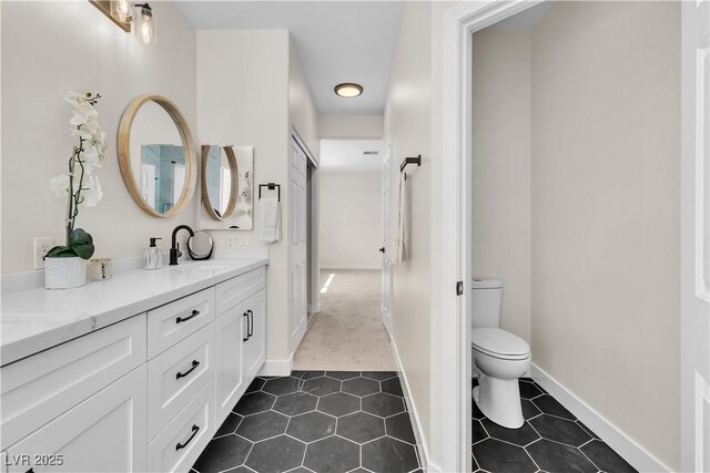 10613 Turquoise Valley Dr, Las Vegas, NV 89144 - bathroom with a sink, toilet, tile patterned floors, double vanity, and baseboards