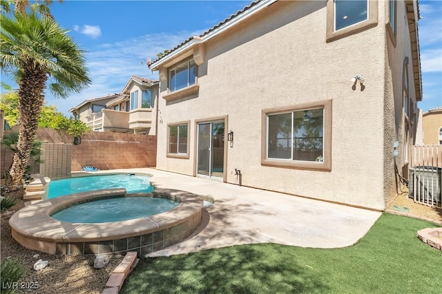 10613 Turquoise Valley Dr, Las Vegas, NV 89144 - rear view of house featuring a fenced backyard, an in ground hot tub, a patio area, and stucco siding