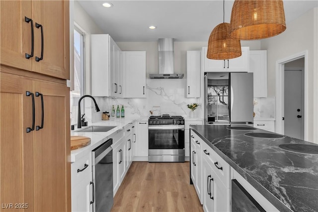 10613 Turquoise Valley Dr, Las Vegas, NV 89144 - kitchen featuring decorative backsplash, dark stone counters, wall chimney exhaust hood, a sink, and stainless steel appliances