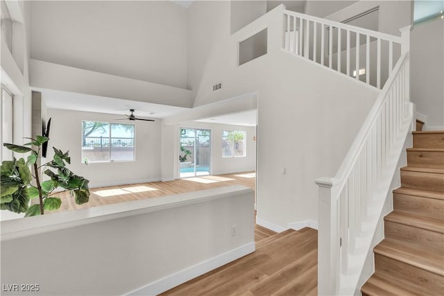 10613 Turquoise Valley Dr, Las Vegas, NV 89144 - stairway with ceiling fan, baseboards, visible vents, and wood finished floors