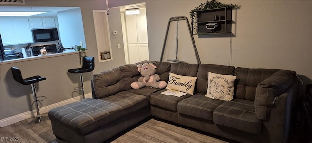 8070 W Russell Rd Unit 1105, Las Vegas, NV 89113 - living room featuring wood finished floors, visible vents, and baseboards