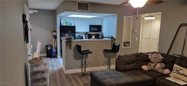 8070 W Russell Rd Unit 1105, Las Vegas, NV 89113 - living room with visible vents, ceiling fan, wood finished floors, and baseboards