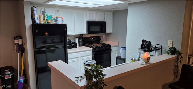 8070 W Russell Rd Unit 1105, Las Vegas, NV 89113 - kitchen featuring white cabinets, a textured wall, light countertops, black appliances, and a peninsula