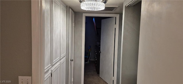 8070 W Russell Rd Unit 1105, Las Vegas, NV 89113 - corridor featuring a chandelier, a textured wall, and carpet floors