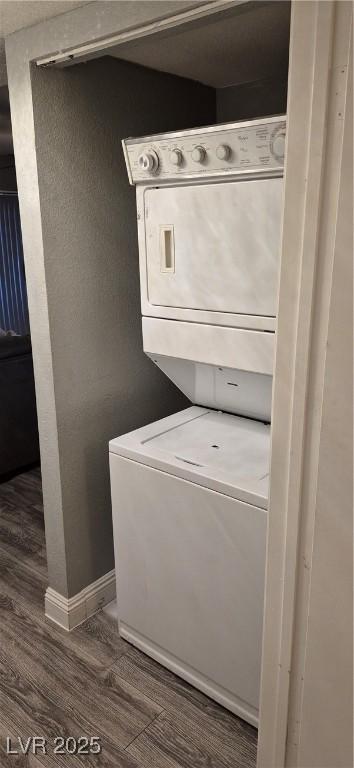 8070 W Russell Rd Unit 1105, Las Vegas, NV 89113 - clothes washing area with stacked washer / dryer, dark wood-style flooring, and baseboards