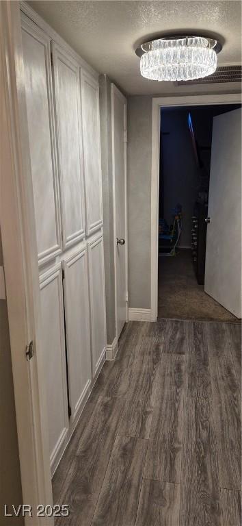 8070 W Russell Rd Unit 1105, Las Vegas, NV 89113 - hall featuring a textured ceiling and dark wood-style flooring