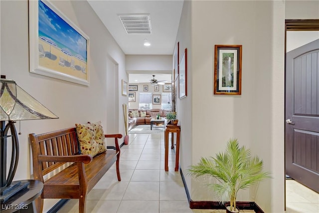 corridor with baseboards, visible vents, light tile patterned floors, and recessed lighting