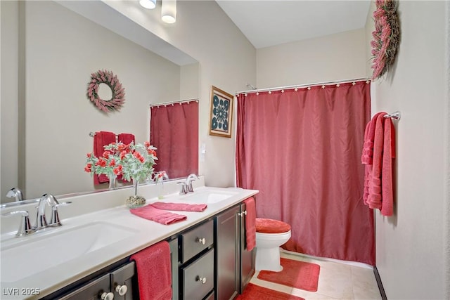 bathroom with toilet, tile patterned flooring, double vanity, and a sink