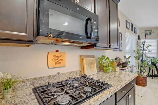 interior details with black appliances and light stone countertops
