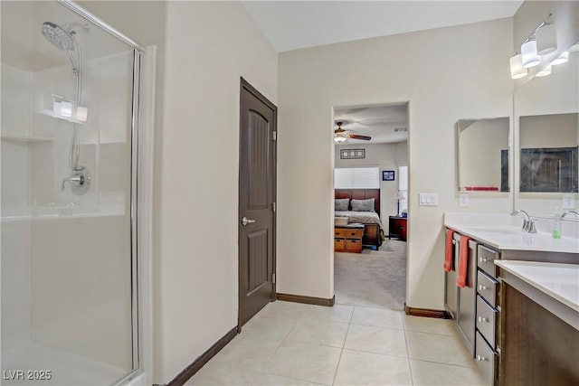 full bathroom with a ceiling fan, a shower stall, and baseboards