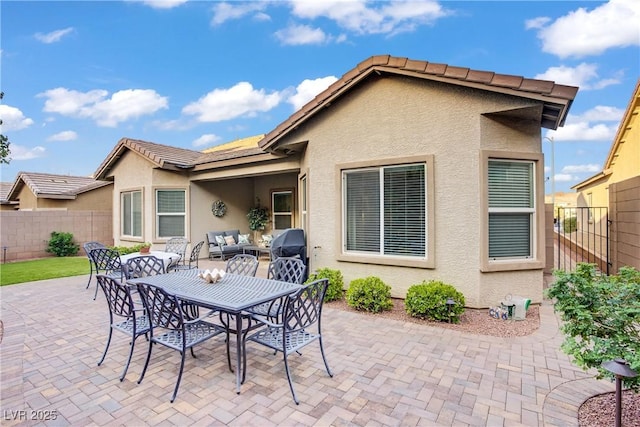 view of patio / terrace featuring fence, an outdoor living space, and outdoor dining area