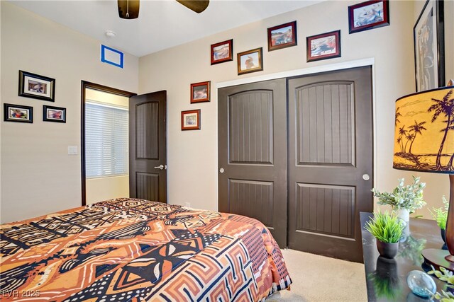 carpeted bedroom featuring a ceiling fan and a closet