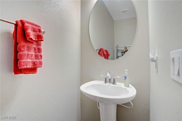 bathroom featuring a sink and visible vents