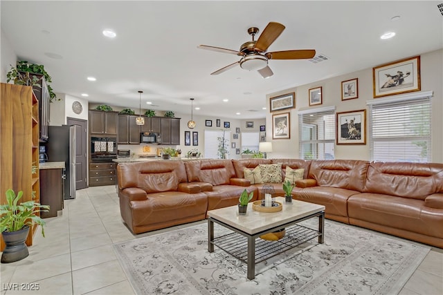 living room with a wealth of natural light, ceiling fan, recessed lighting, and visible vents