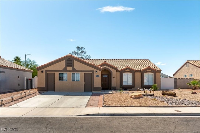 5005 Chambliss Dr, Las Vegas, NV 89130 - mediterranean / spanish-style house with a tile roof, stucco siding, fence, and driveway