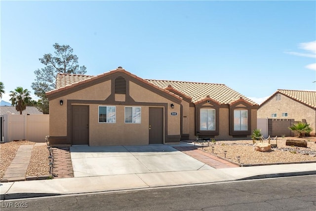 5005 Chambliss Dr, Las Vegas, NV 89130 - view of front facade featuring a tile roof, stucco siding, and fence