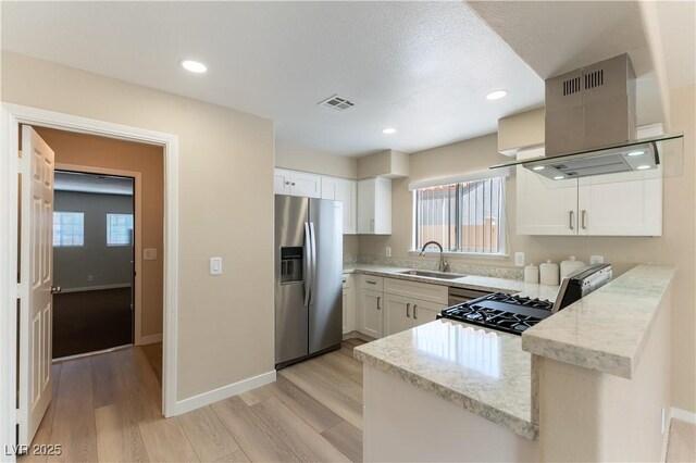5005 Chambliss Dr, Las Vegas, NV 89130 - kitchen with stainless steel fridge, a sink, light wood-type flooring, light stone countertops, and white cabinetry