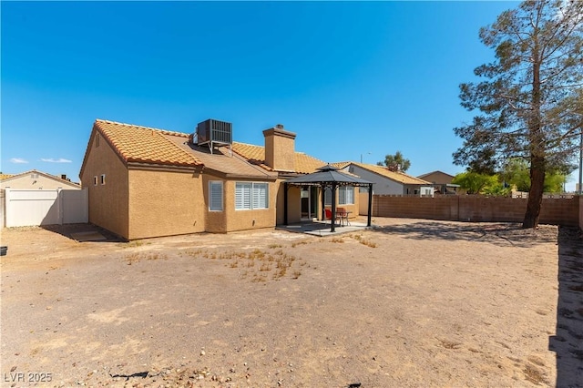 5005 Chambliss Dr, Las Vegas, NV 89130 - rear view of house with a gazebo, a chimney, a tiled roof, stucco siding, and a patio