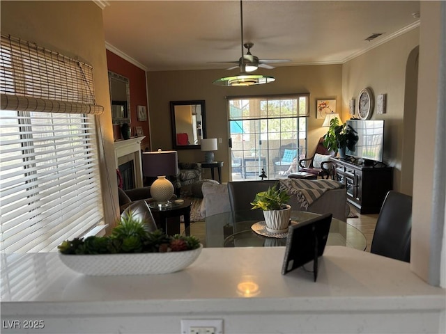 1851 Hillpointe Rd Unit 2621, Henderson, NV 89074 - dining area with a fireplace, arched walkways, a ceiling fan, visible vents, and ornamental molding