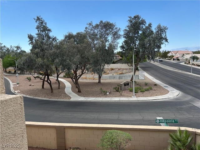view of road with sidewalks, curbs, and street lighting