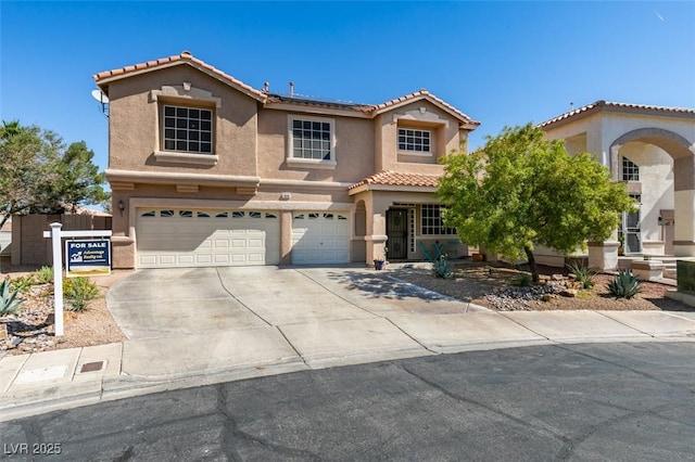 1048 Painted Daisy Ave, Henderson, NV 89074 - mediterranean / spanish house with an attached garage, stucco siding, concrete driveway, and a tile roof