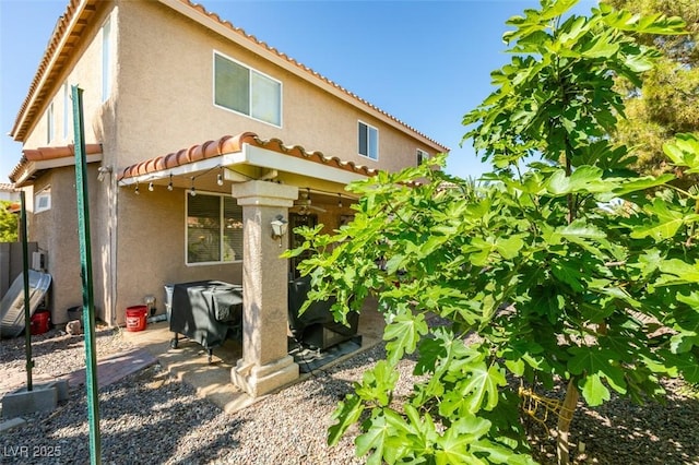 1048 Painted Daisy Ave, Henderson, NV 89074 - rear view of house featuring stucco siding and a tiled roof