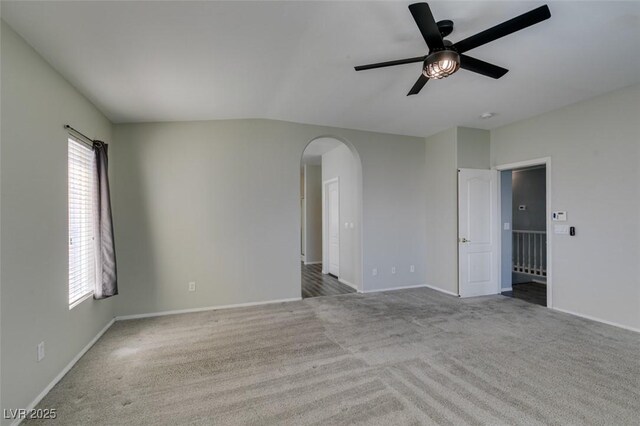 1048 Painted Daisy Ave, Henderson, NV 89074 - unfurnished room featuring carpet floors, arched walkways, a ceiling fan, and plenty of natural light