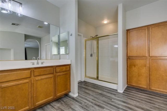 1048 Painted Daisy Ave, Henderson, NV 89074 - bathroom with a shower stall, wood finished floors, and vanity
