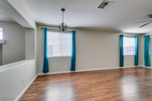 1048 Painted Daisy Ave, Henderson, NV 89074 - spare room with wood-type flooring and a chandelier