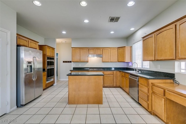 1048 Painted Daisy Ave, Henderson, NV 89074 - kitchen with appliances with stainless steel finishes, a center island, dark countertops, recessed lighting, and light tile patterned floors