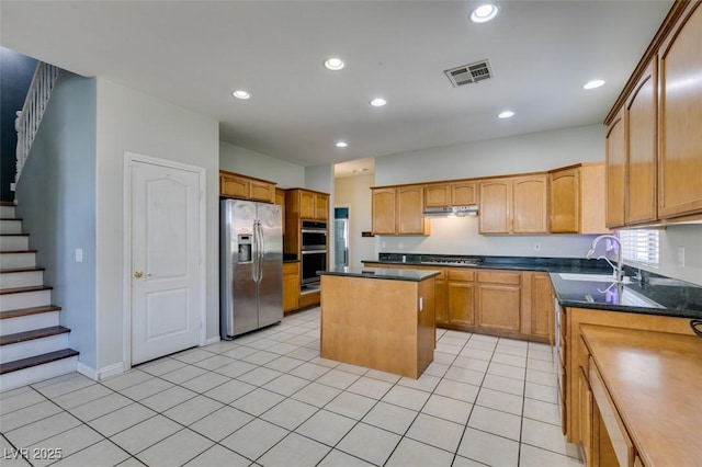 1048 Painted Daisy Ave, Henderson, NV 89074 - kitchen featuring appliances with stainless steel finishes, a center island, recessed lighting, dark countertops, and under cabinet range hood