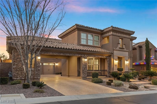 2717 Mona Lisa St, Henderson, NV 89044 - mediterranean / spanish-style home with covered porch, stone siding, a garage, a tile roof, and concrete driveway