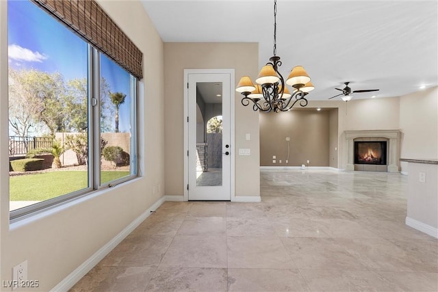 2717 Mona Lisa St, Henderson, NV 89044 - unfurnished dining area featuring plenty of natural light, a chandelier, baseboards, and a lit fireplace