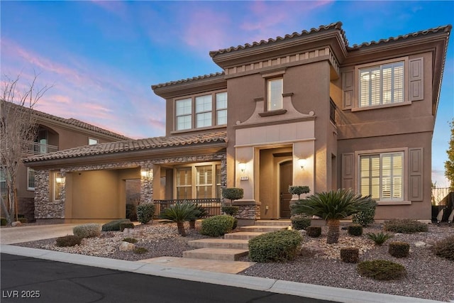 2717 Mona Lisa St, Henderson, NV 89044 - view of front of house featuring a porch, stucco siding, a tile roof, and stone siding