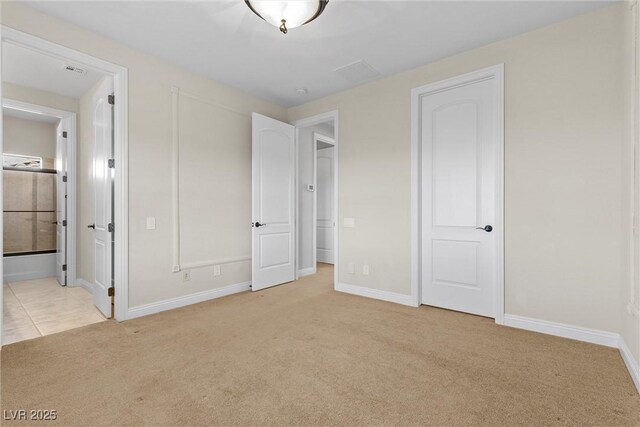 2717 Mona Lisa St, Henderson, NV 89044 - unfurnished bedroom featuring light colored carpet, baseboards, and ensuite bath