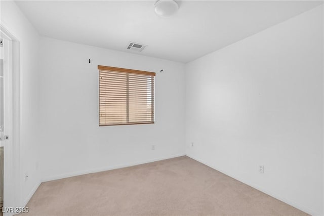 unfurnished room with baseboards, visible vents, and carpet floors
