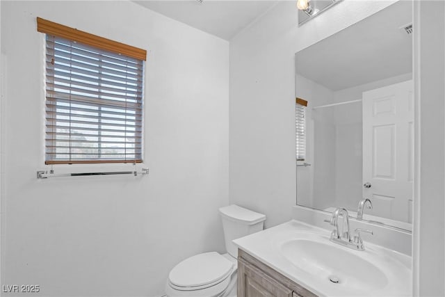 full bath featuring toilet, visible vents, and vanity