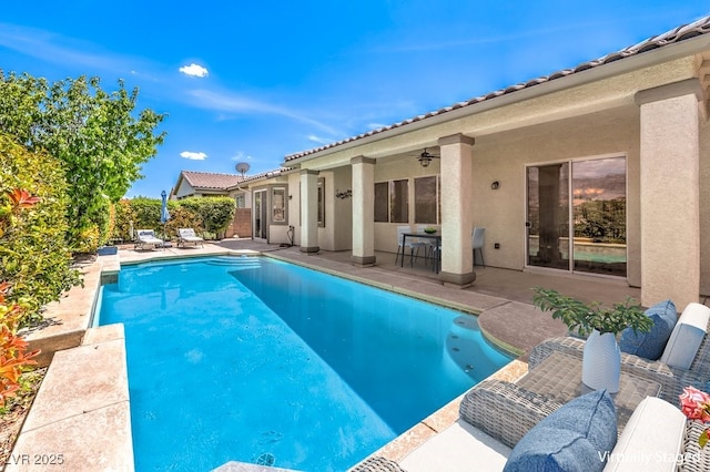 view of swimming pool with a patio, ceiling fan, and a fenced in pool