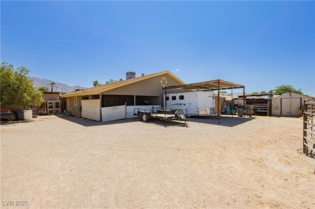 997 N Christy Ln, Las Vegas, NV 89110 - rear view of house with an outbuilding, an exterior structure, a mountain view, and a carport