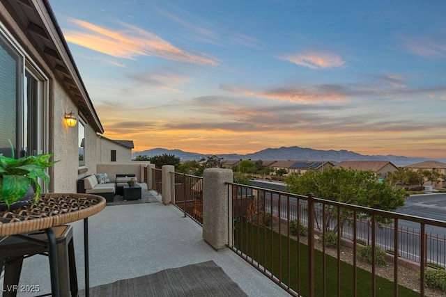 7364 Marbury St, Las Vegas, NV 89166 - patio terrace at dusk featuring an outdoor hangout area, a balcony, and a mountain view