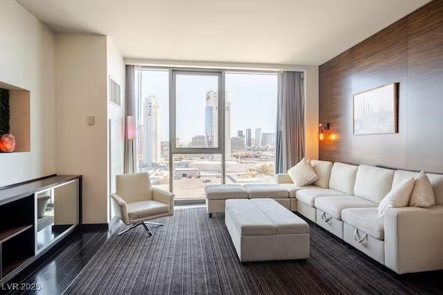 living area with floor to ceiling windows, plenty of natural light, and a city view